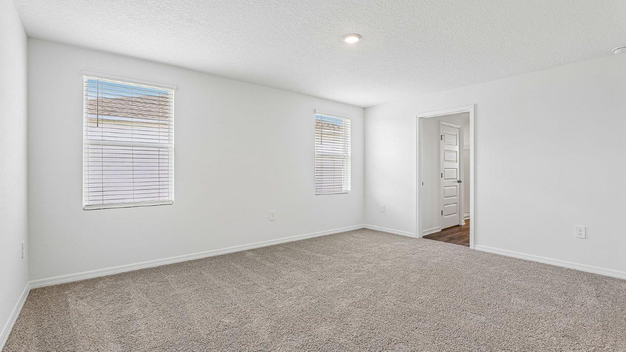 primary bedroom with carpet