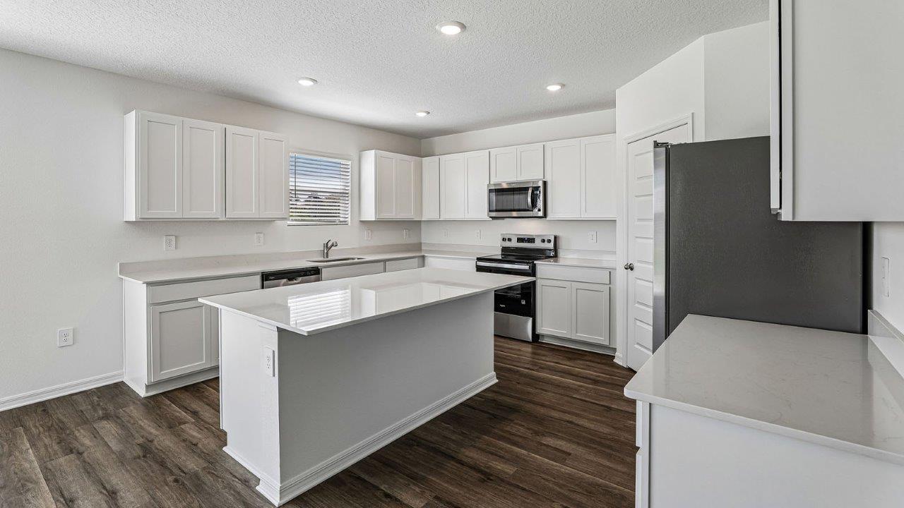 large kitchen with white cabinets