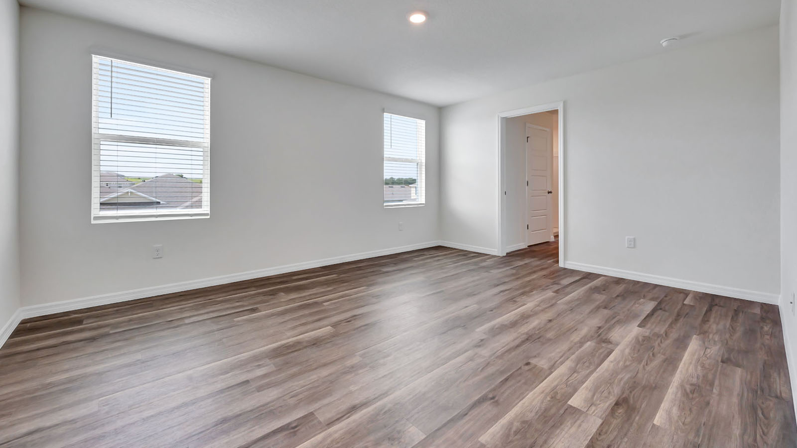 Primary bedroom with luxury vinyl plank and ensuite bathroom