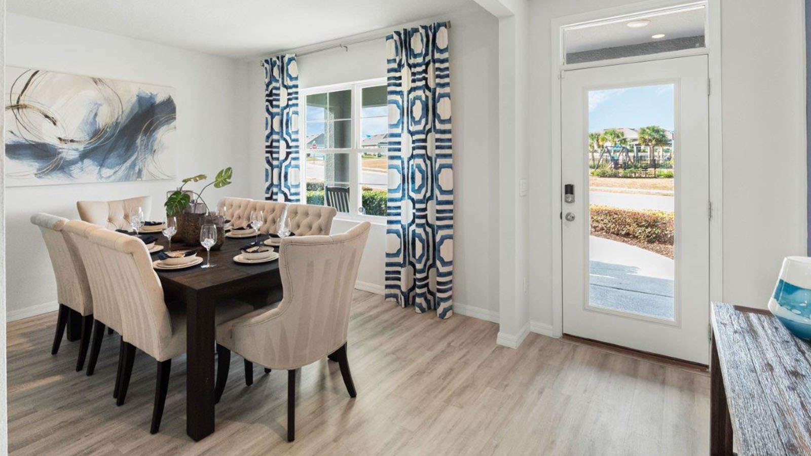 Entry and flex room staged as dining area