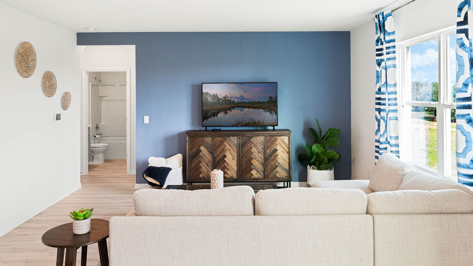 Living room with hallway to garage and downstairs bedroom and bathroom