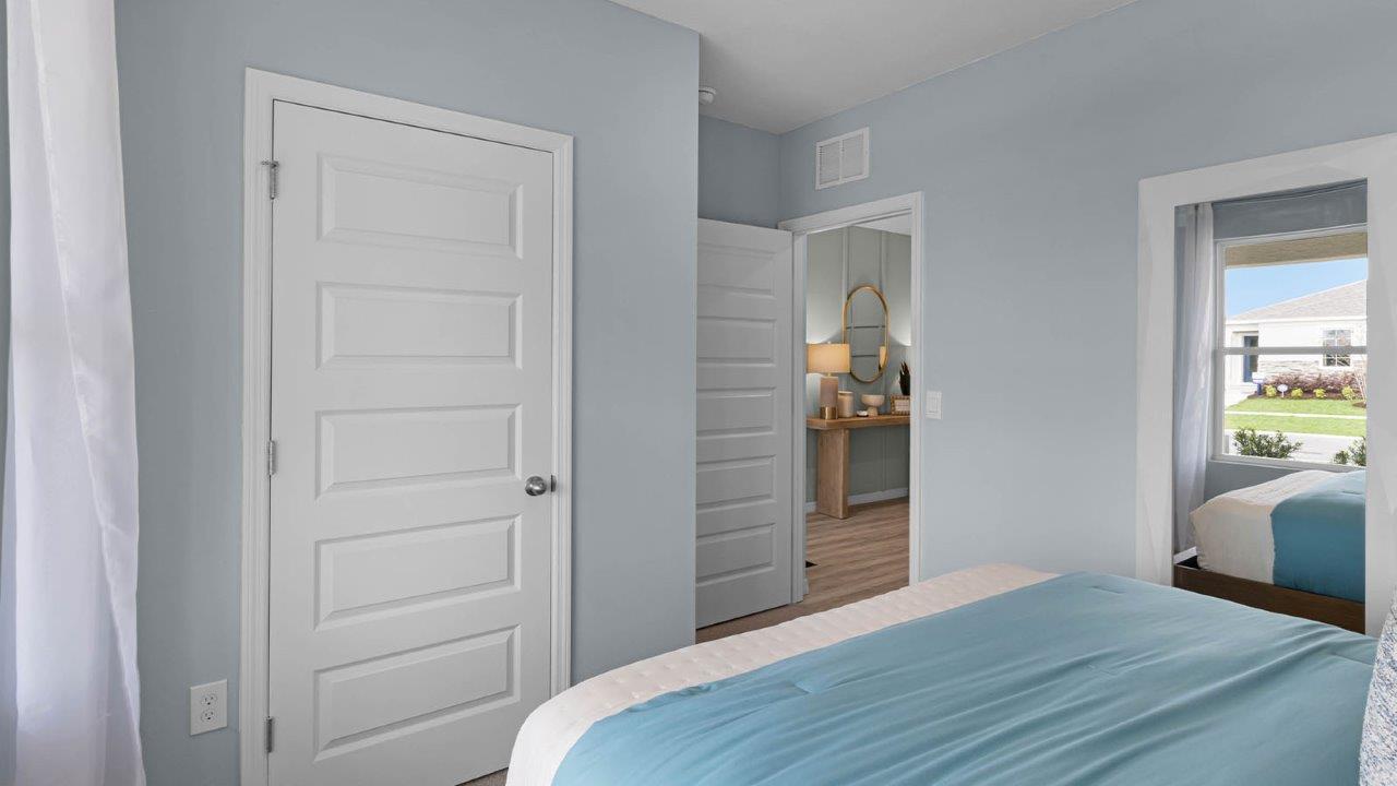 Guest bedroom with queen size bed and closet