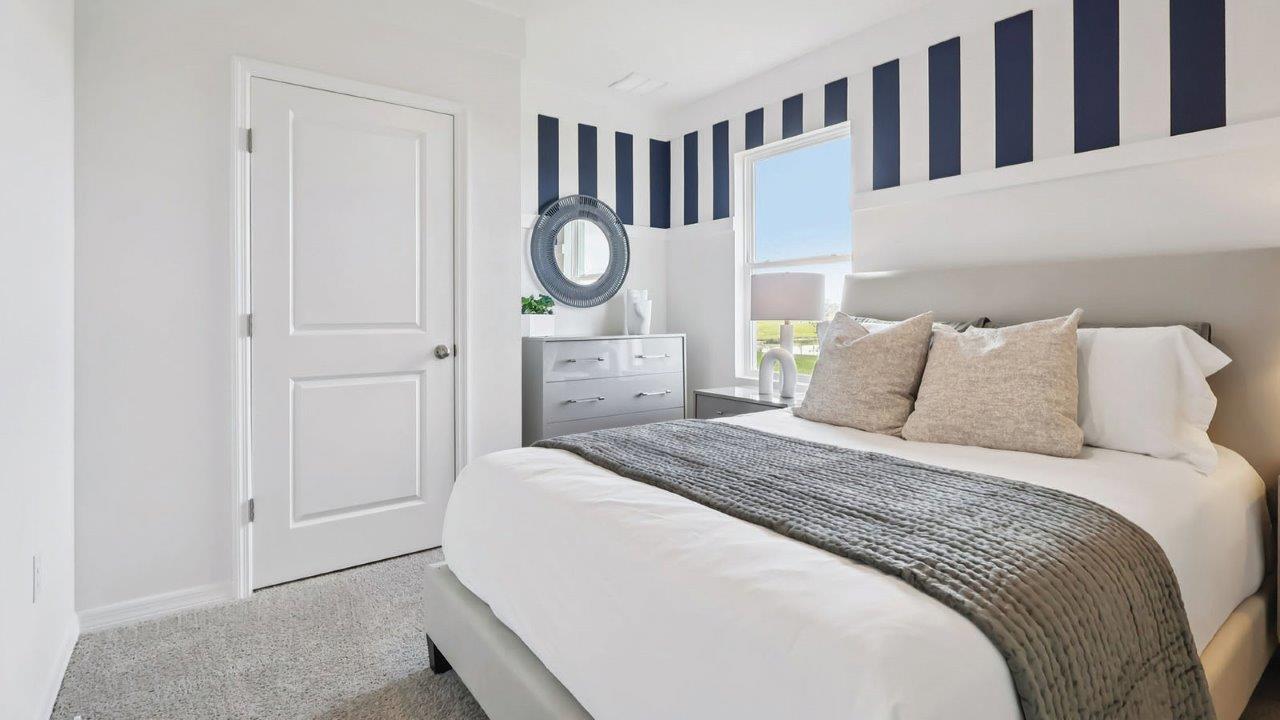 Bedroom with queen size bed and dresser