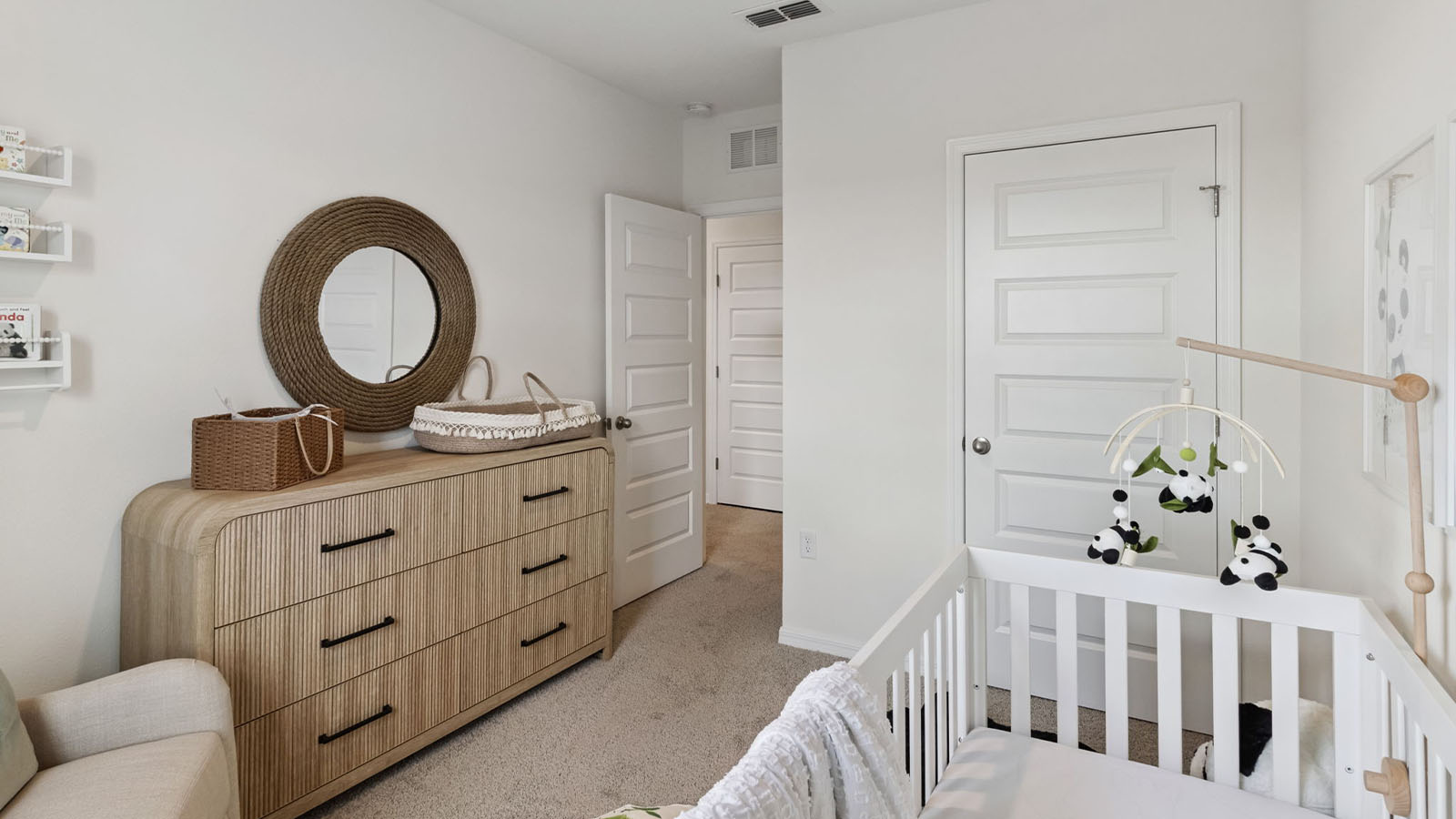 Dresser, closet, and crib in nursery