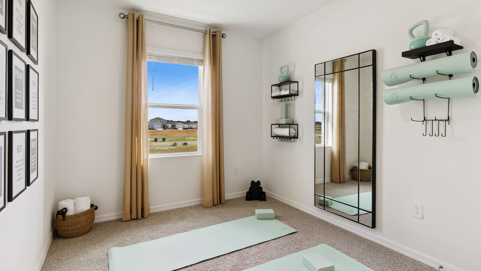 Guest bedroom staged as a yoga room with mats and mirror