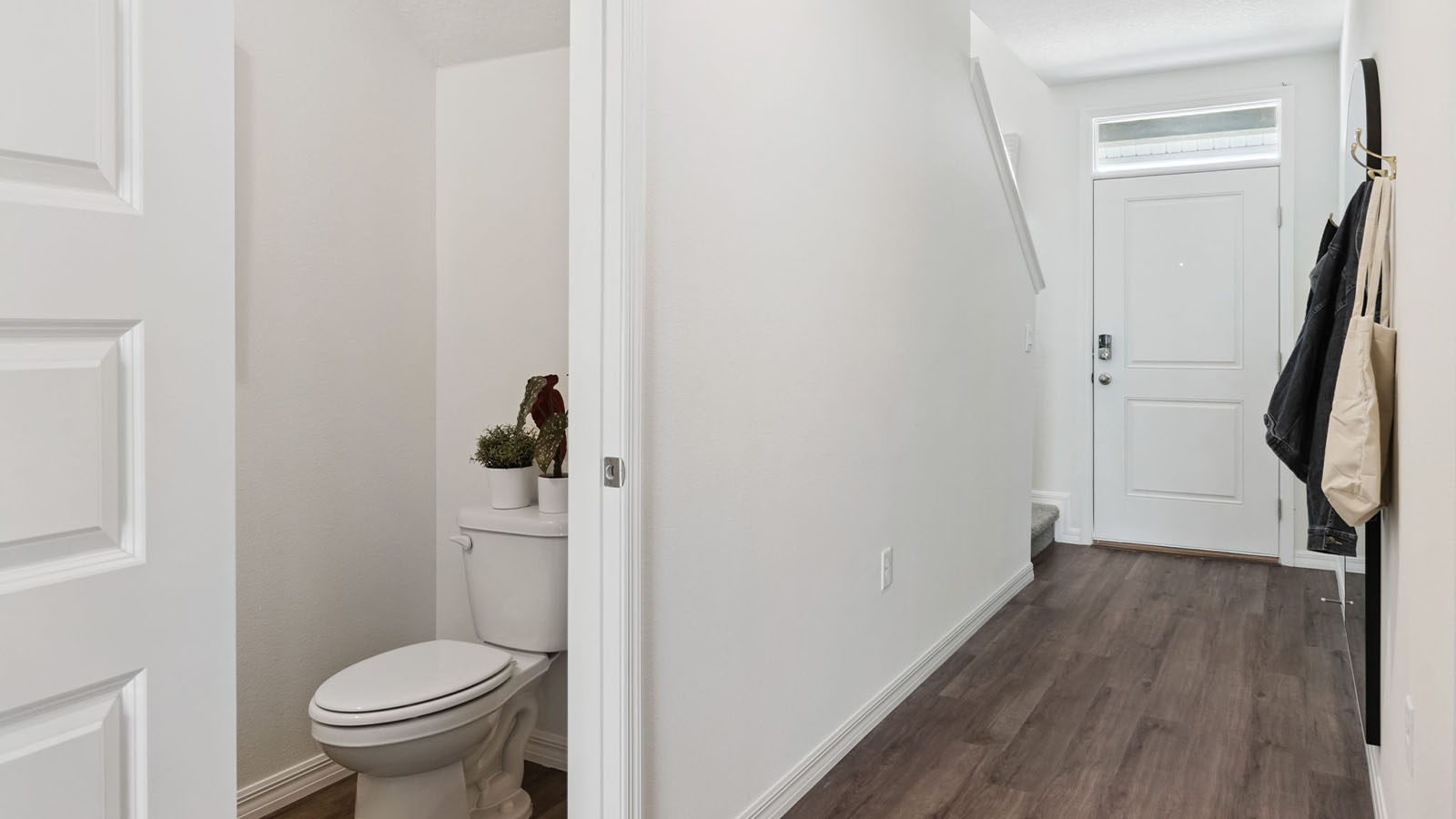 Entrance with half bathroom and stairs to second floor