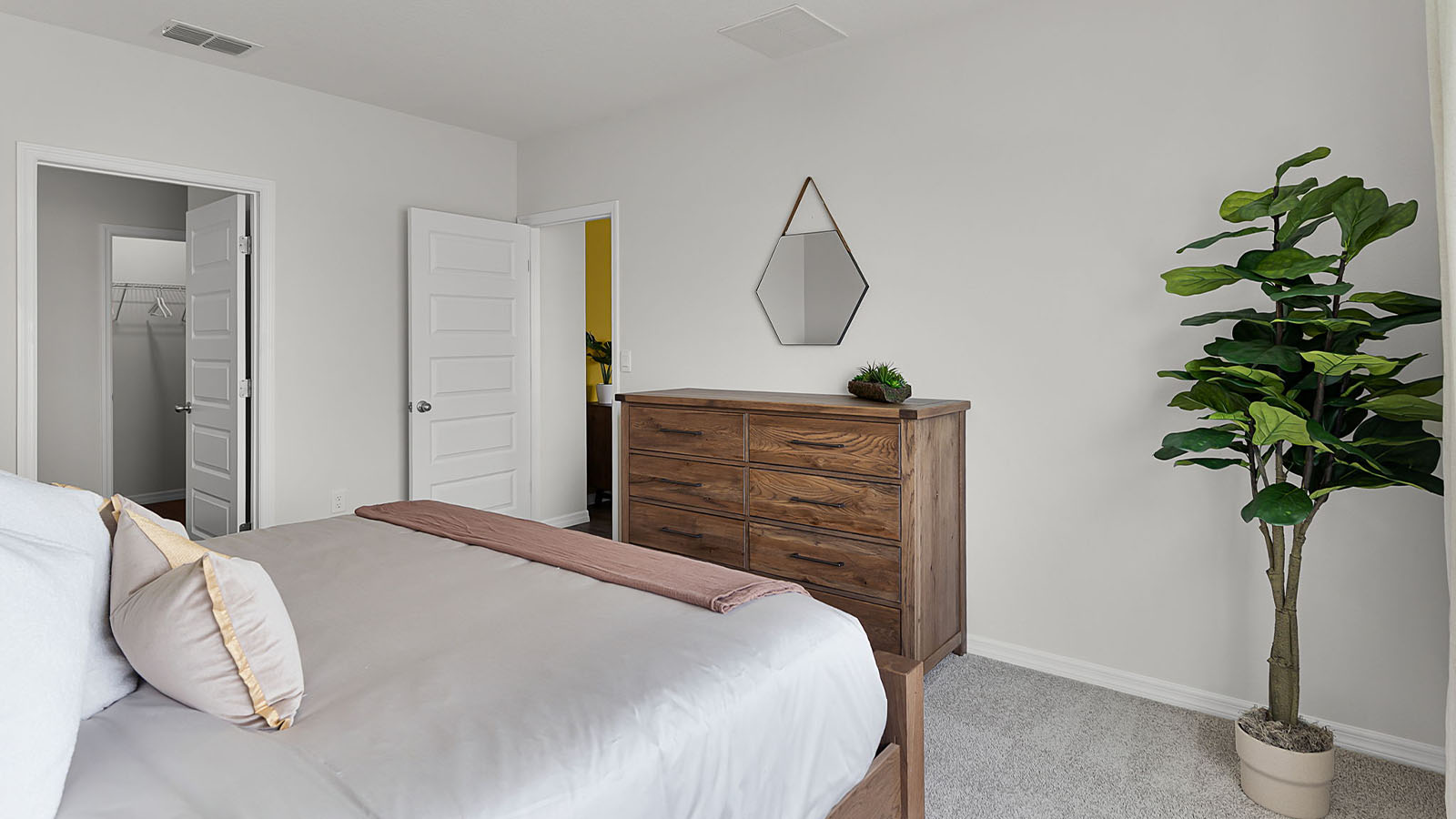 Primary bedroom with view of door and ensuite bathroom