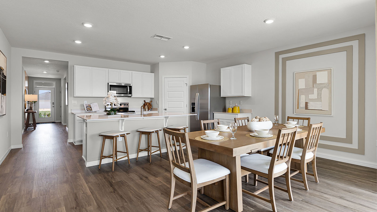 Wide shot of kitchen, dining room and entry way