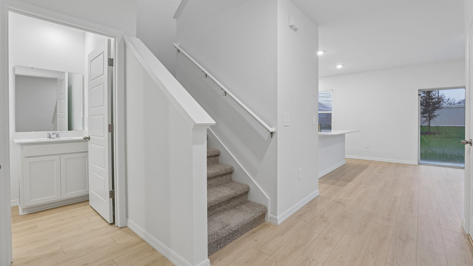 Entry way of the home with a bathroom and stairs