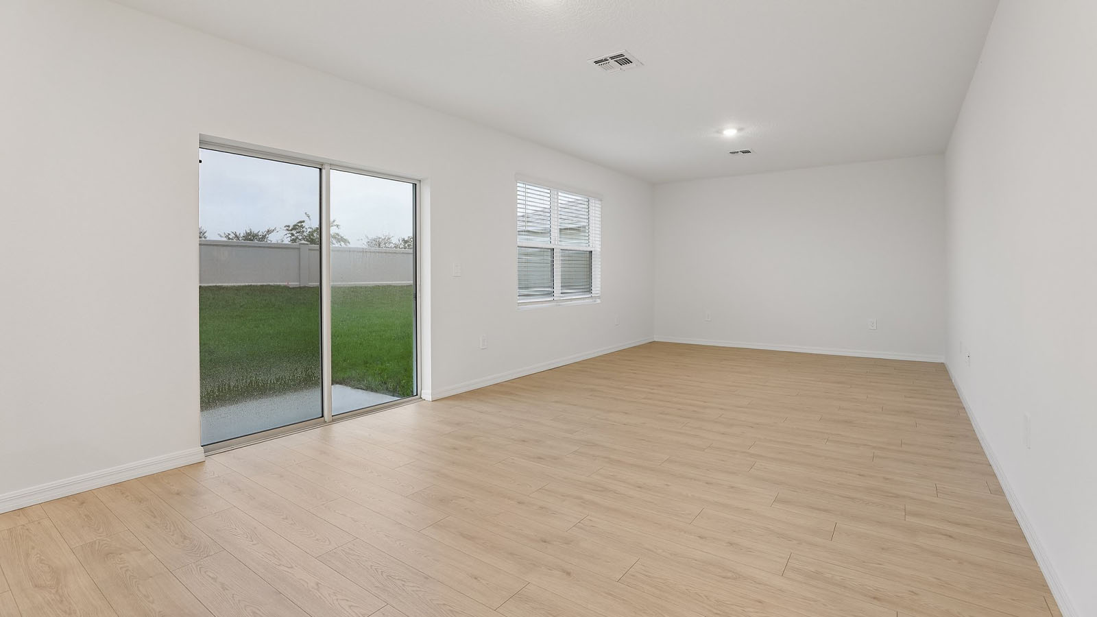 Living room with a sliding door leading to the backyard