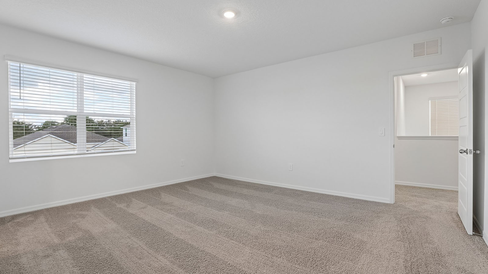 Primary bedroom with carpet throughout