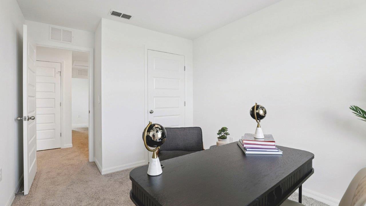 Office with desk, bookshelf and sitting area