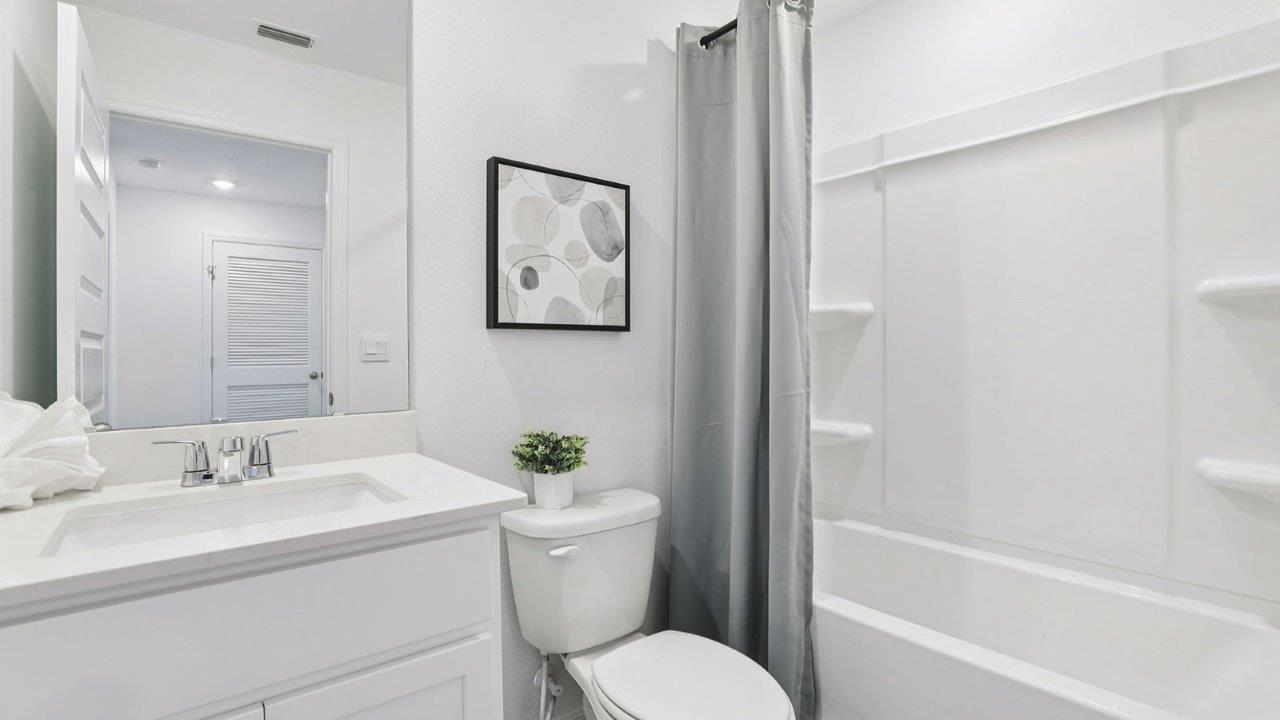 Guest bathroom with tub and single vanity sink