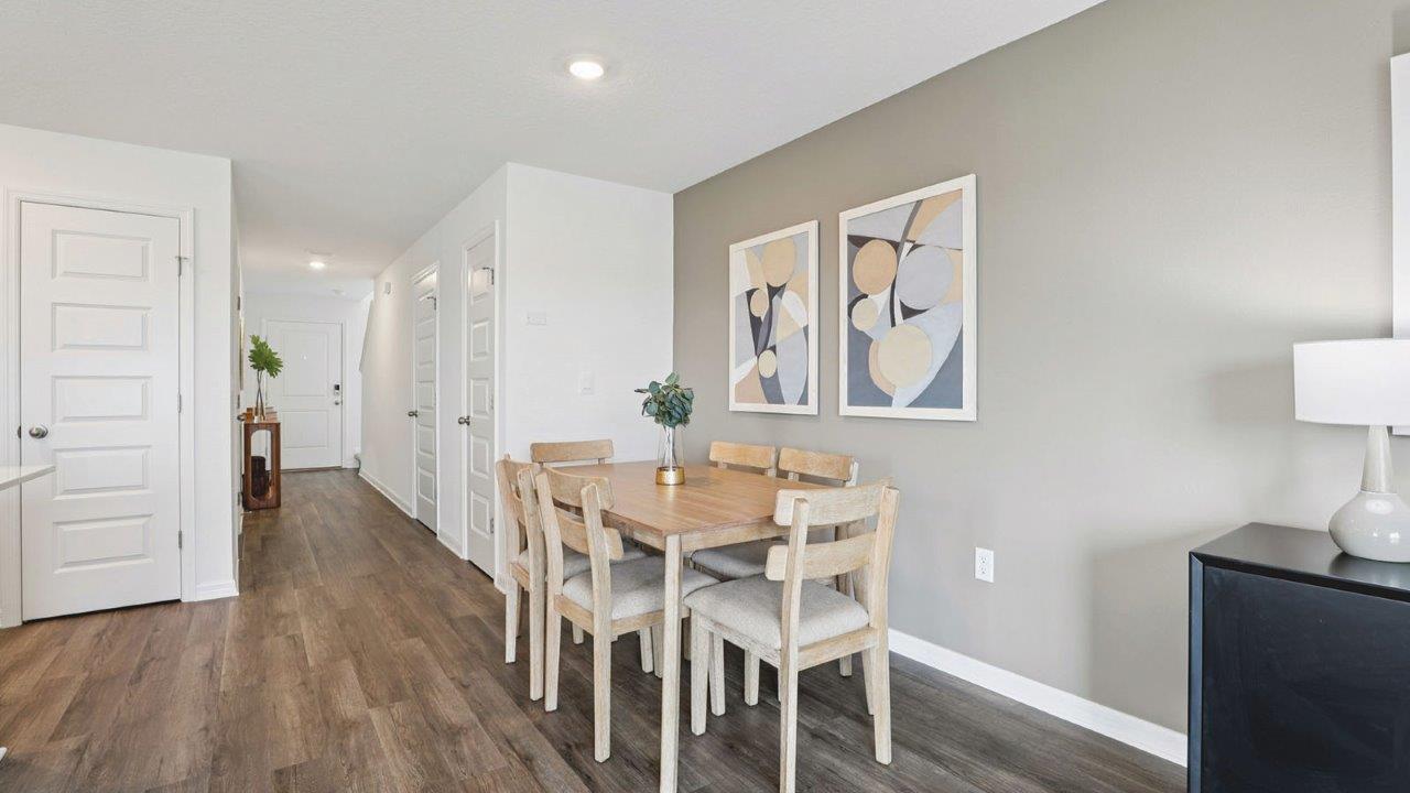 Dining room with 4 person round table looking to the entry way