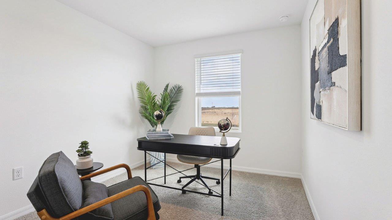 Office with desk, bookshelf and sitting area