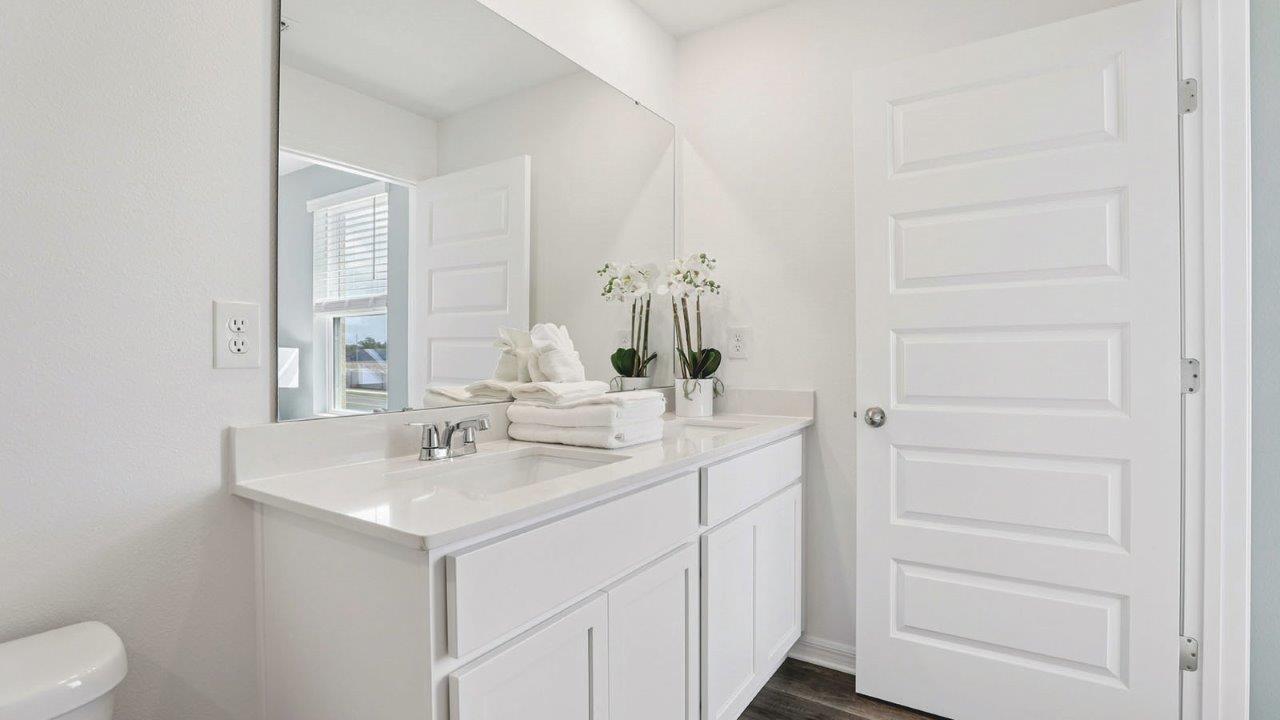 Primary bathroom attached bathroom with double vanity sinks and walk in shower