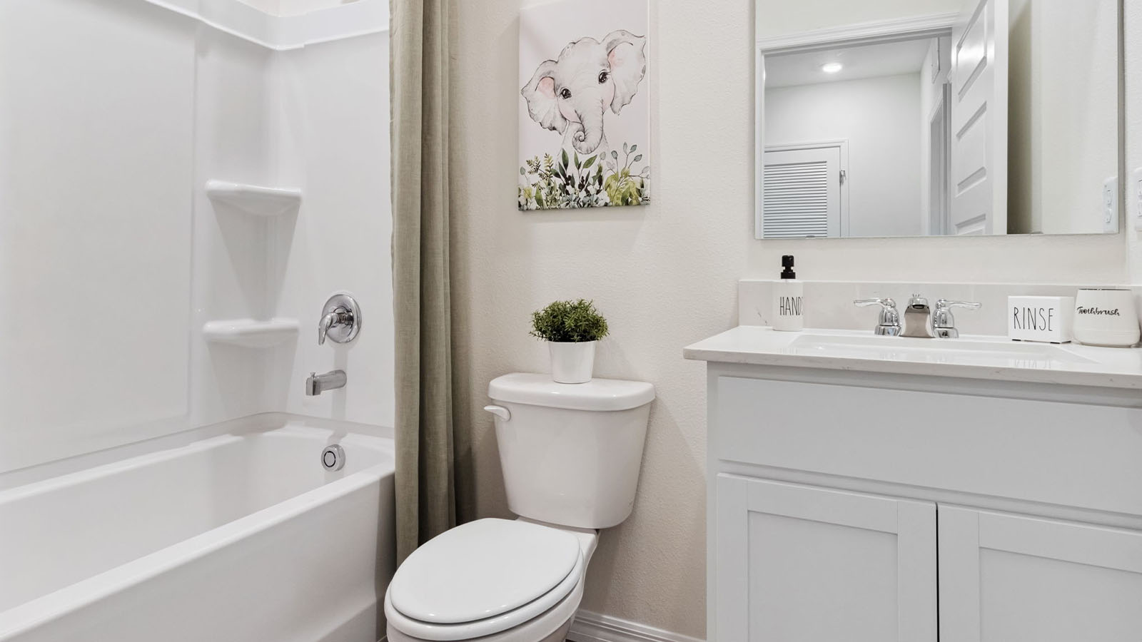Guest bathroom with tub and single vanity sink
