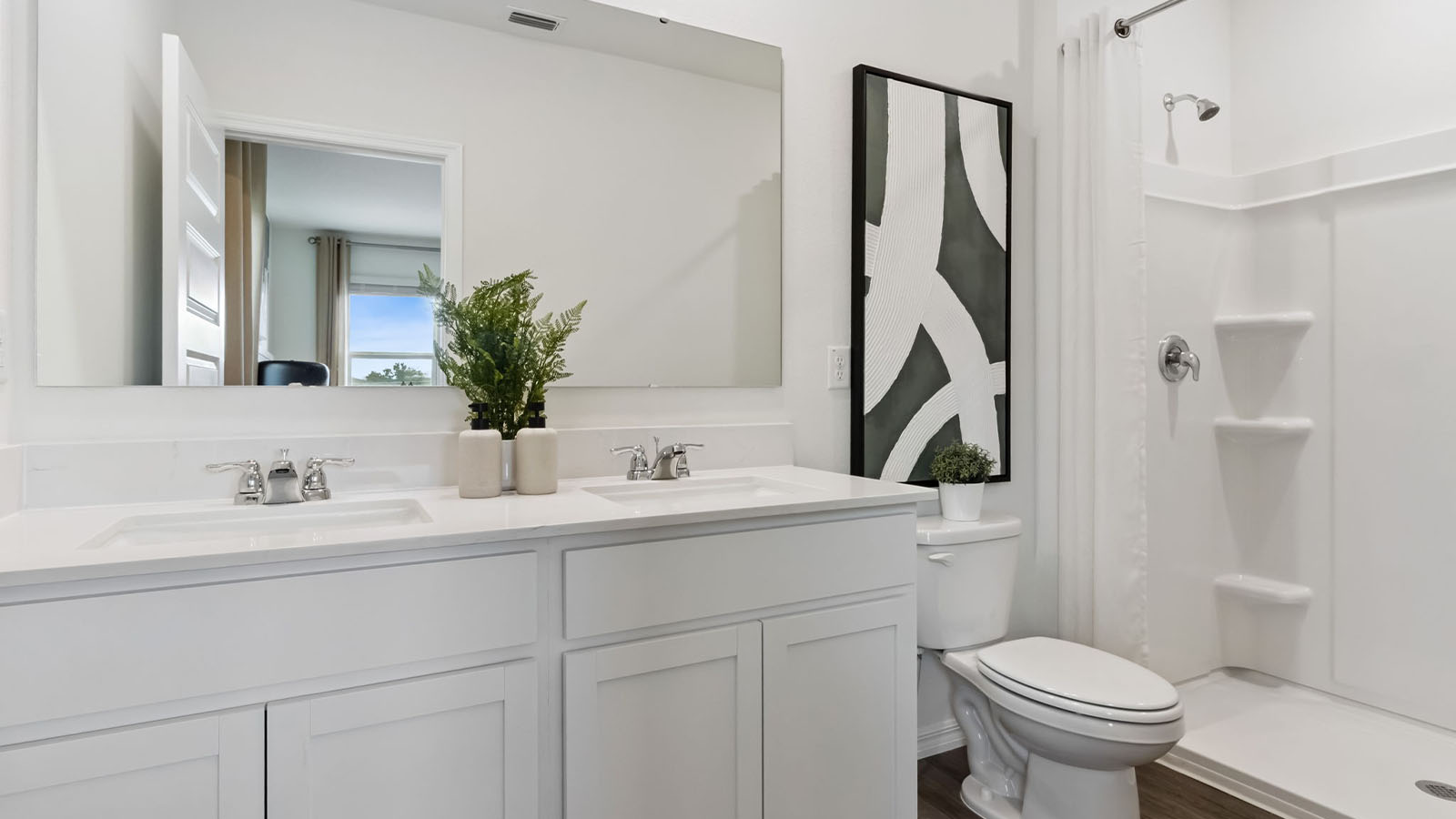 Primary bathroom attached bathroom with double vanity sinks and walk in shower