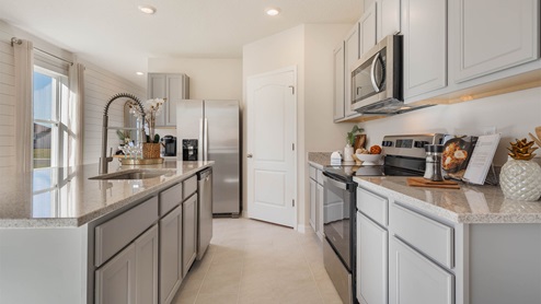 Kitchen area with white cabinets and granite countertop