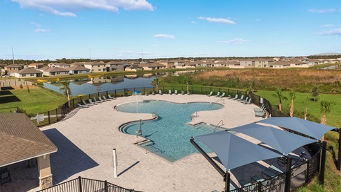 resort-style pool with beach entry and cabanas