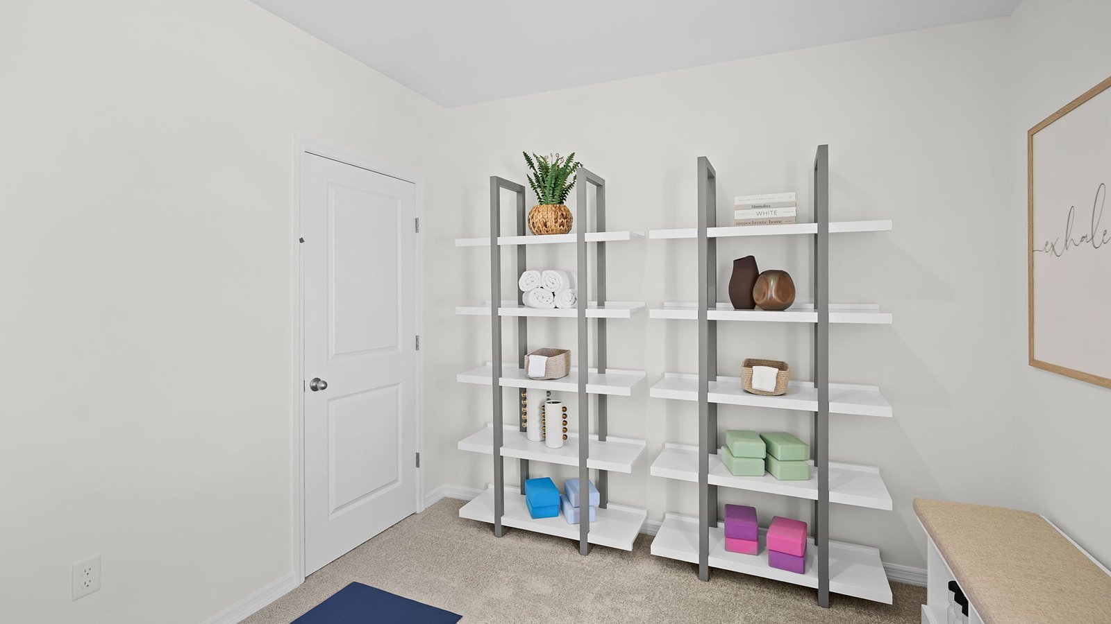Guest bedroom staged as yoga room with fitness equiptment on shelves