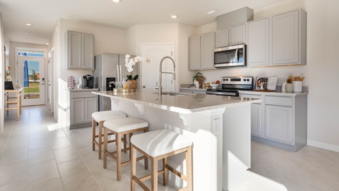 Kitchen near the hallway leading to the entrance of the home
