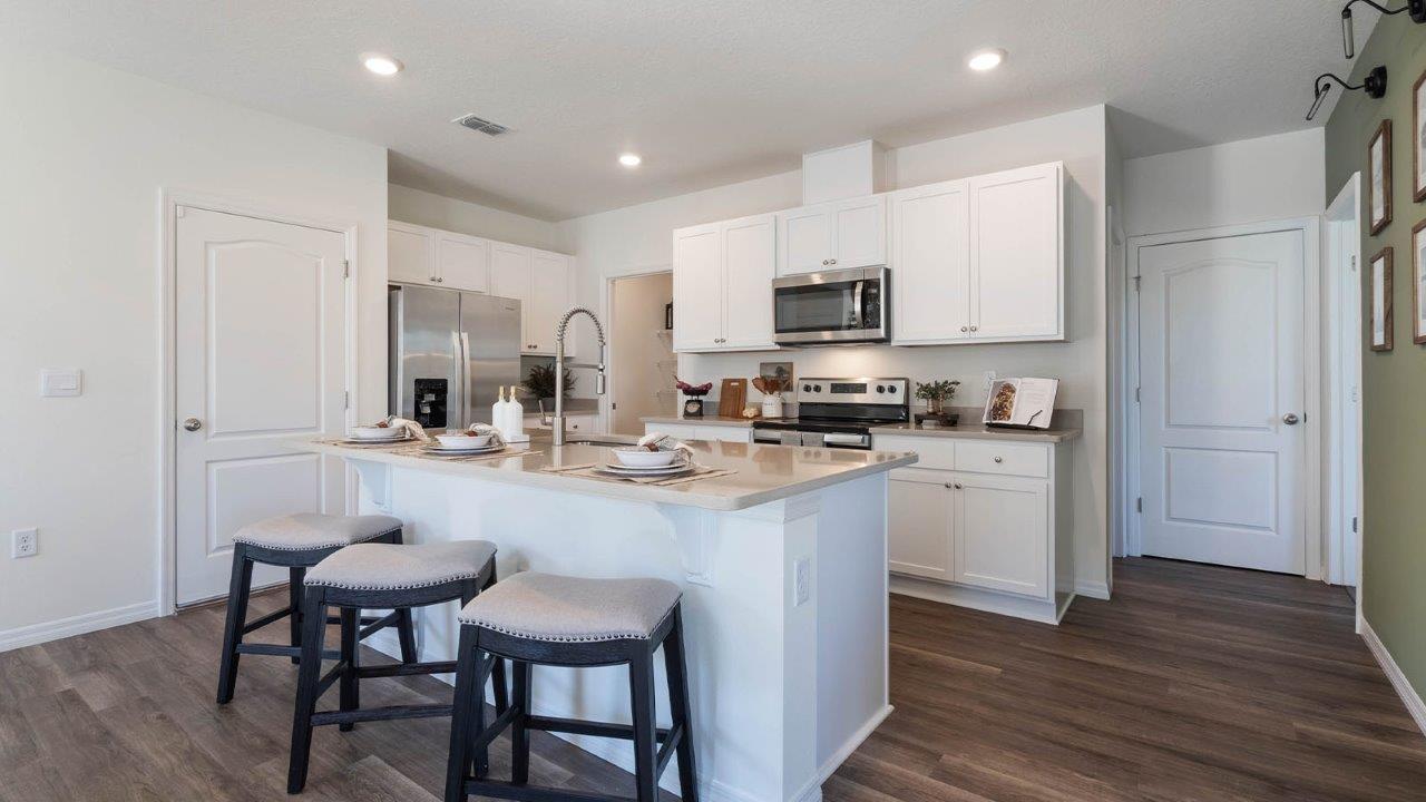 Open concept kitchen with walk in pantry and stainless-steel appliances