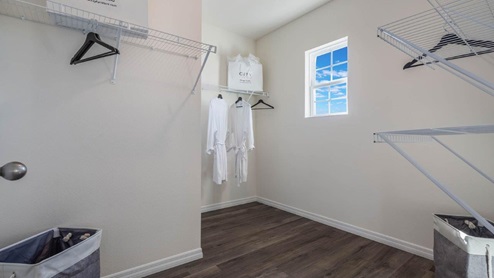main-floor guest bathroom with walk in shower and white cabinets