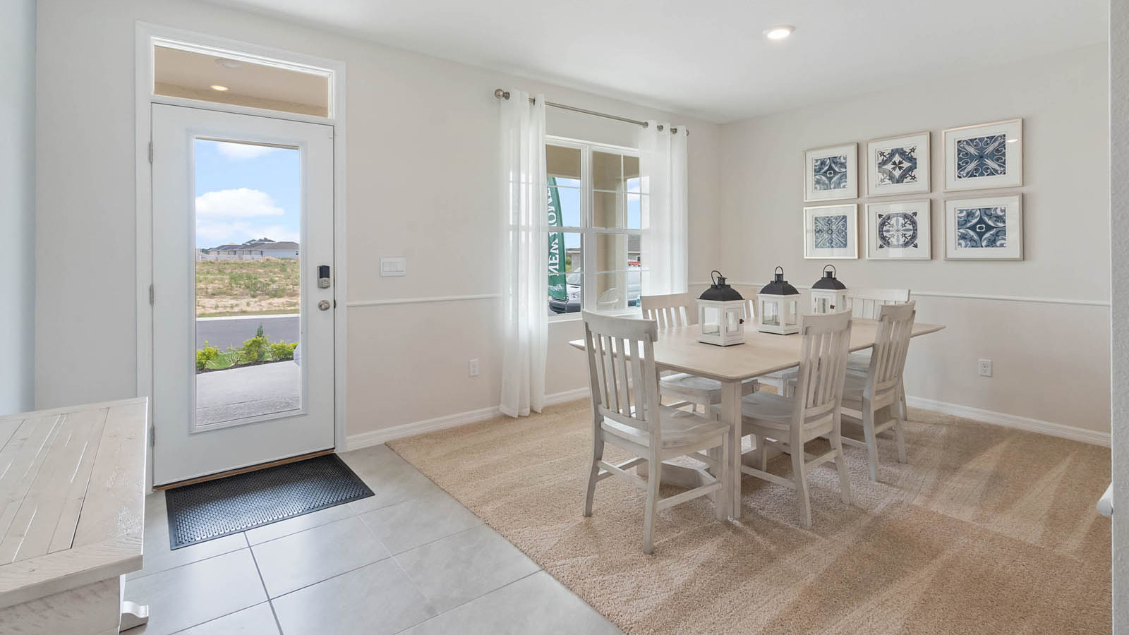 entrance to the home with ceramic tile and dining room to the right