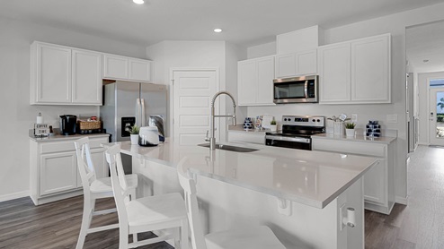 Kitchen Island with view of hallway leading to the front door