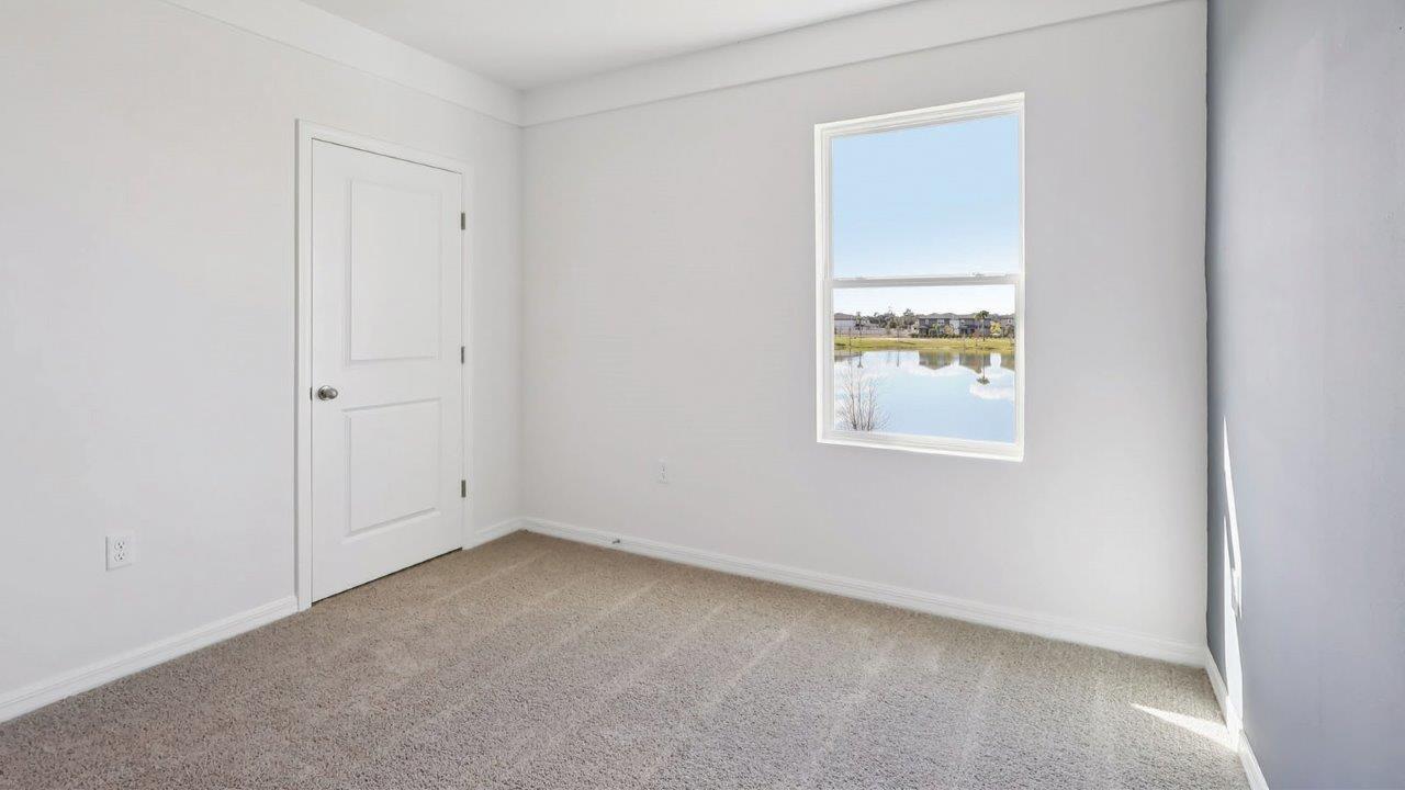Guest bedroom with window and closet