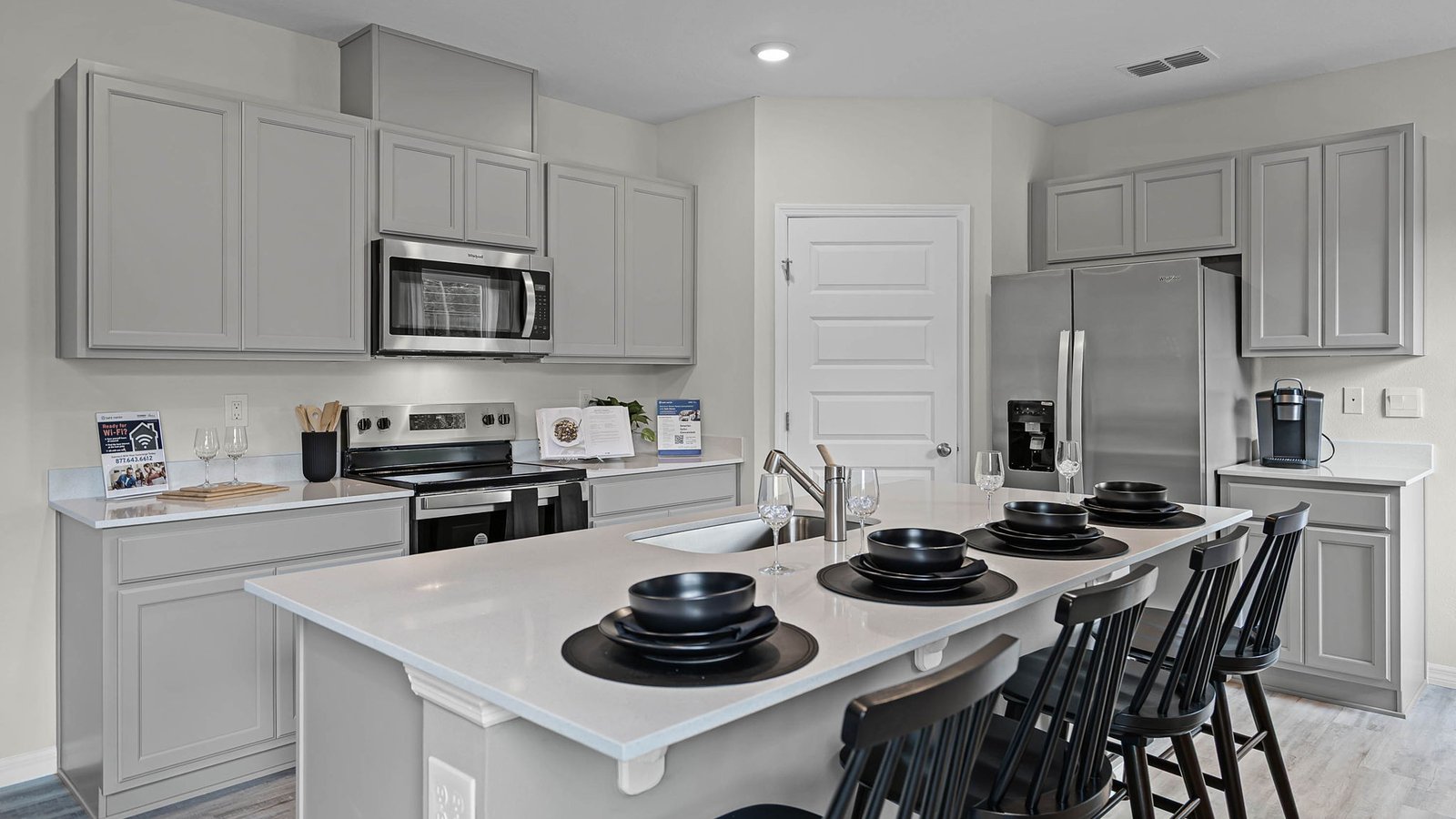 Kitchen island with granite counter-tops and stainless steel appliances