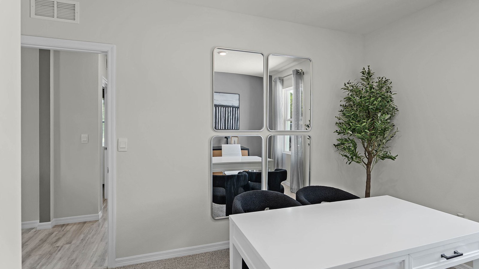guest bedroom converted into an office with carpet throughout