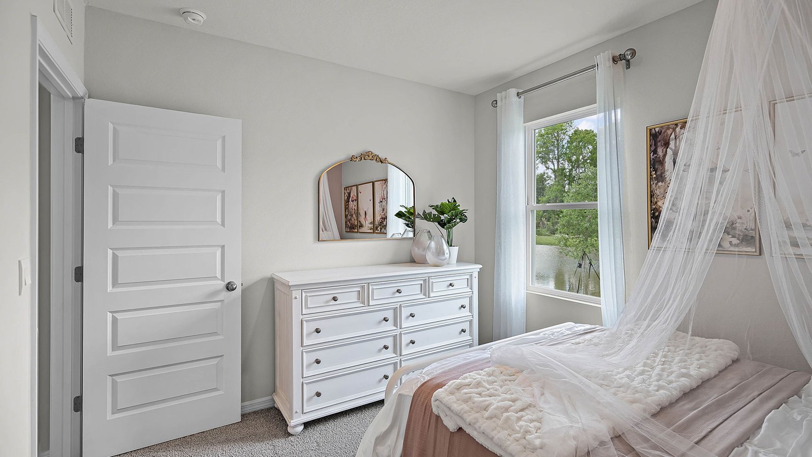 guest bedroom with full bed and vanity