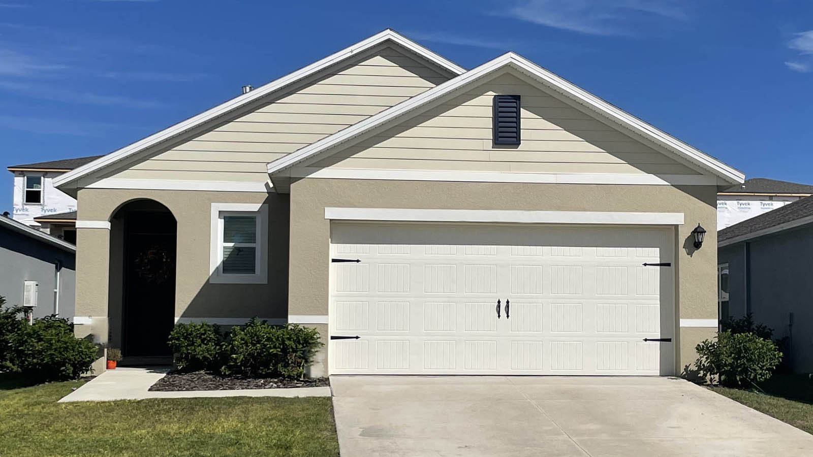 single-story home with covered front door and two-car garage