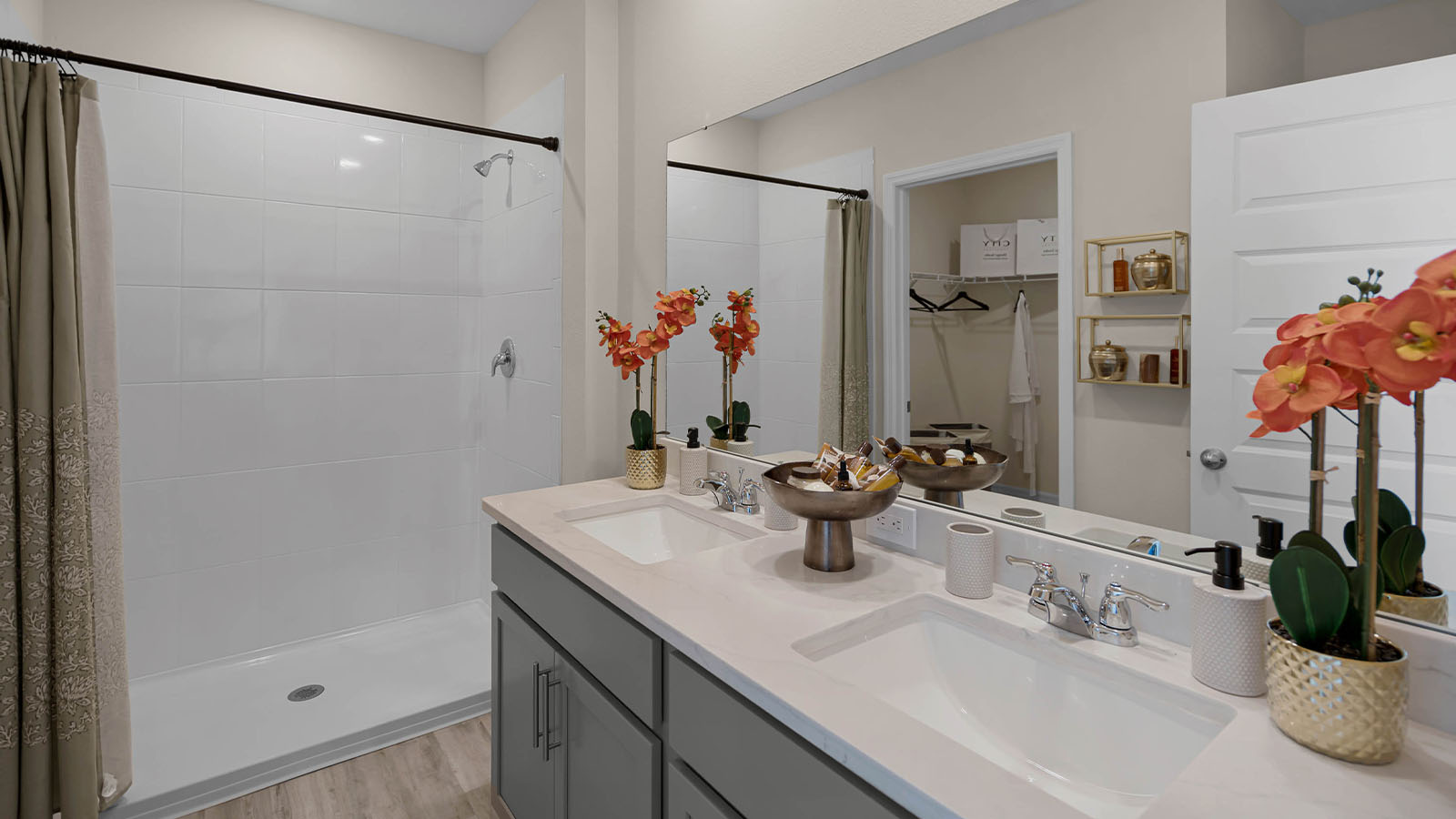 Primary bathroom with dual vanity sink and walk in shower