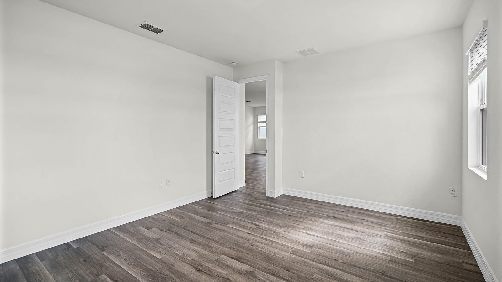 primary bedroom with door to primary bathroom