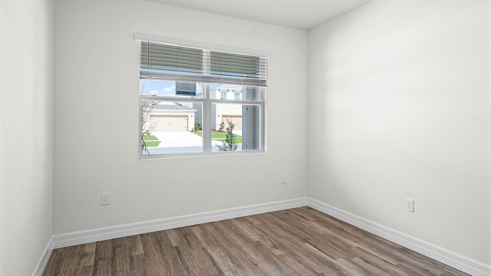 guest bedroom with window and luxury vinyl flooring