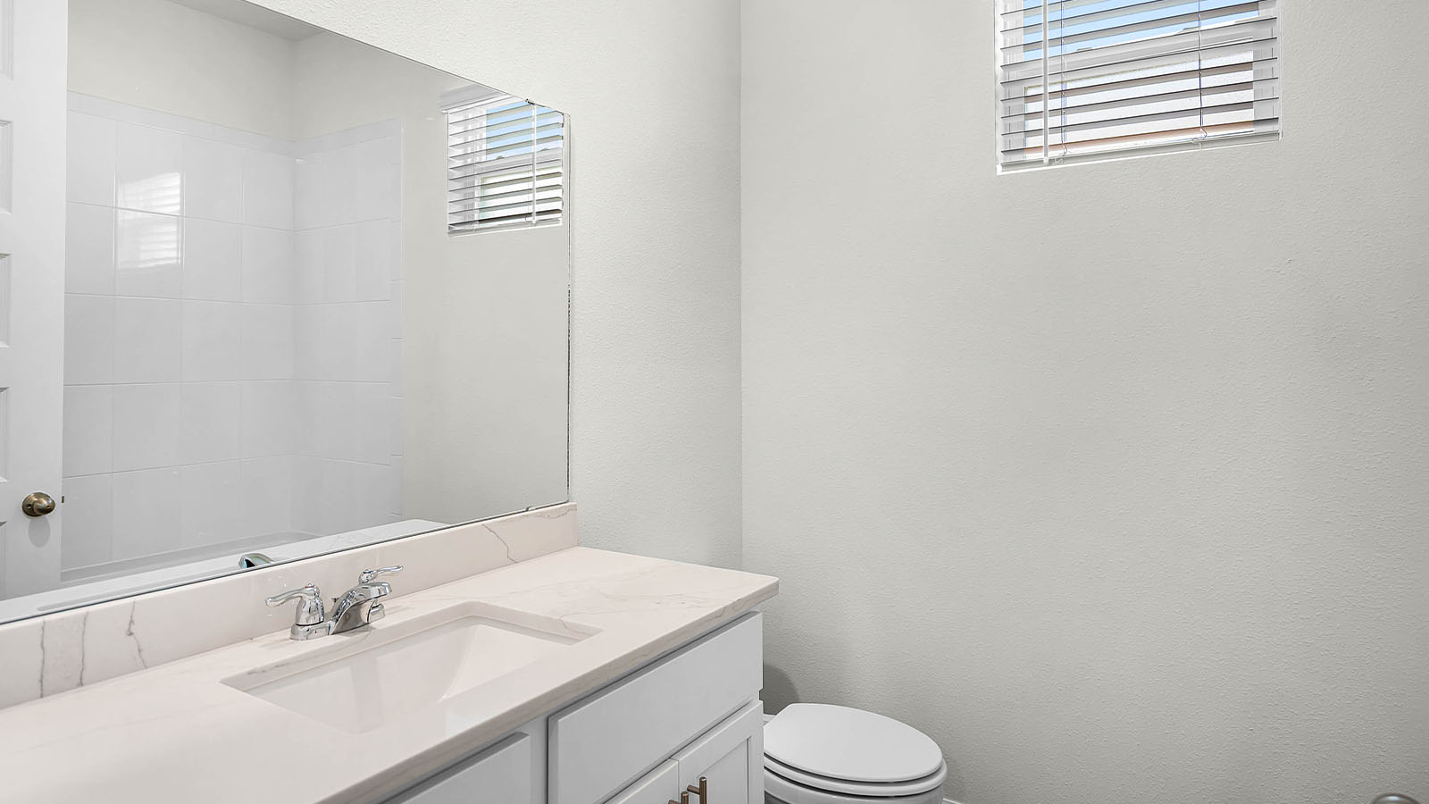 guest bathroom with sink and mirror