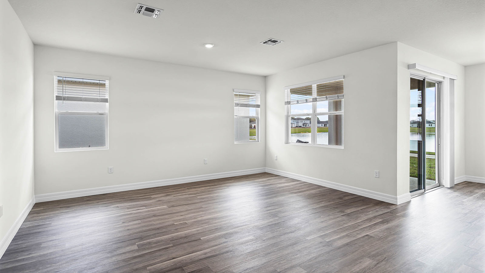 living room with luxury vinyl plank flooring and sliding glass door to the backayrd
