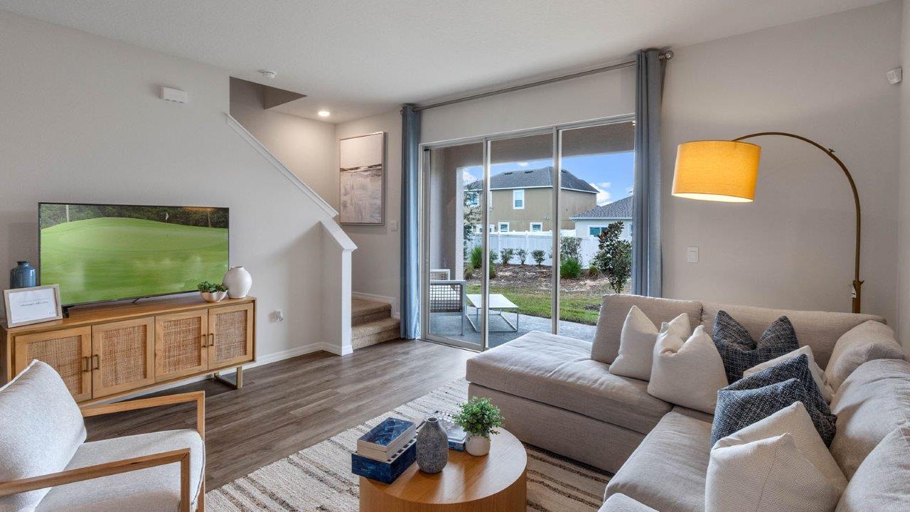 Living room view from couch with view of stairs and outdoor patio