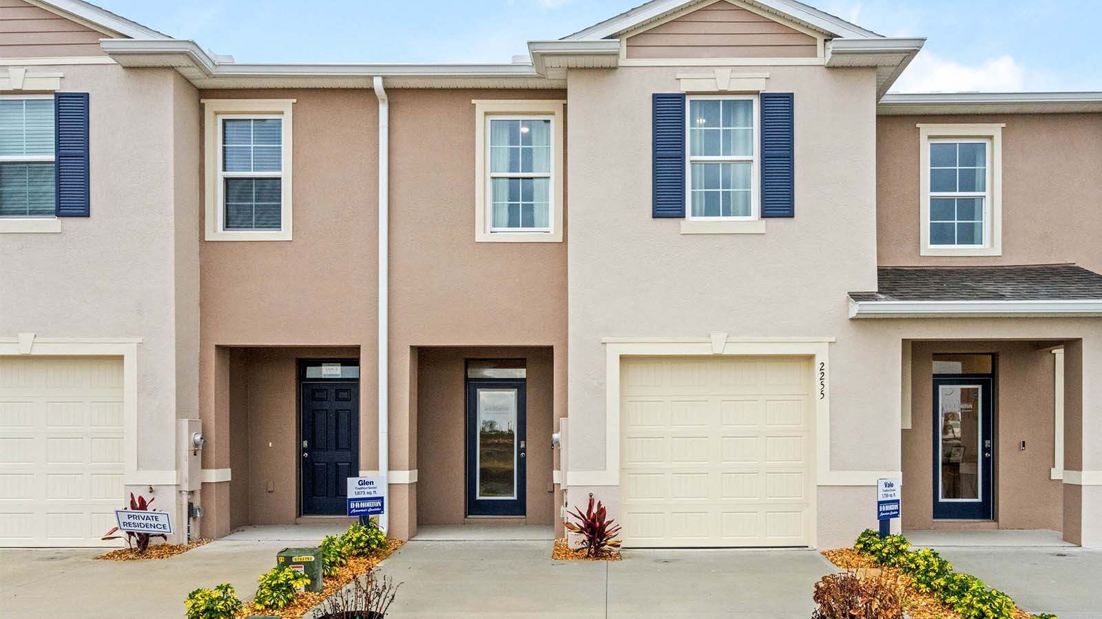 Exterior image of two story townhome and single car garage