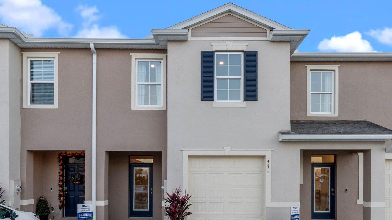 Exterior image of two story townhome and single car garage