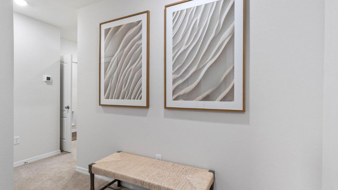 Upstairs hallway with bench and artwork