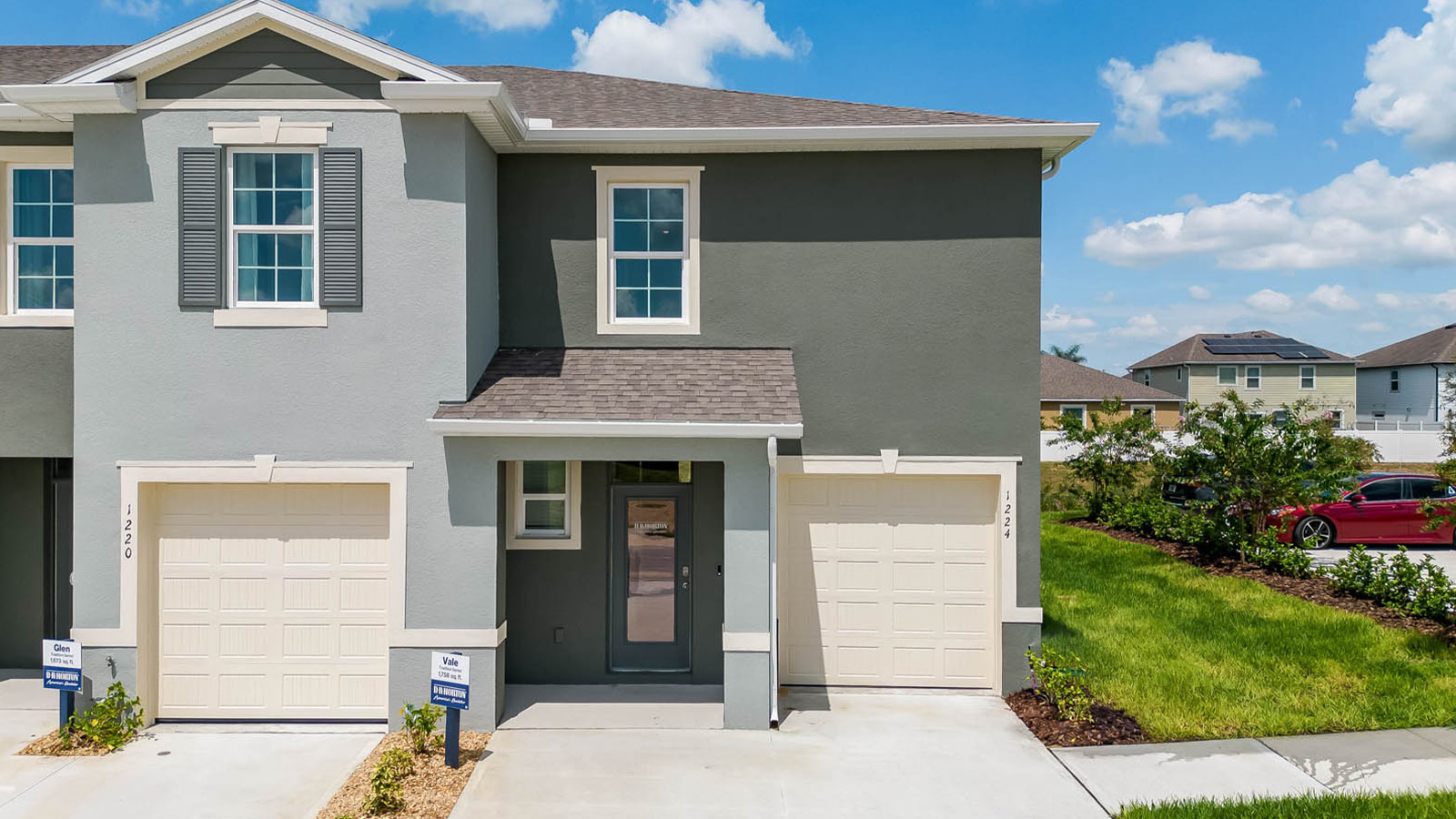 Exterior image of two story townhome and single car garage