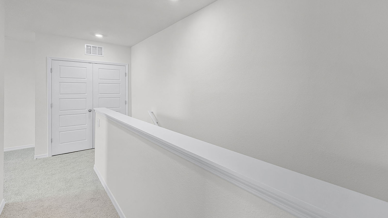 upstairs hallway with carpet