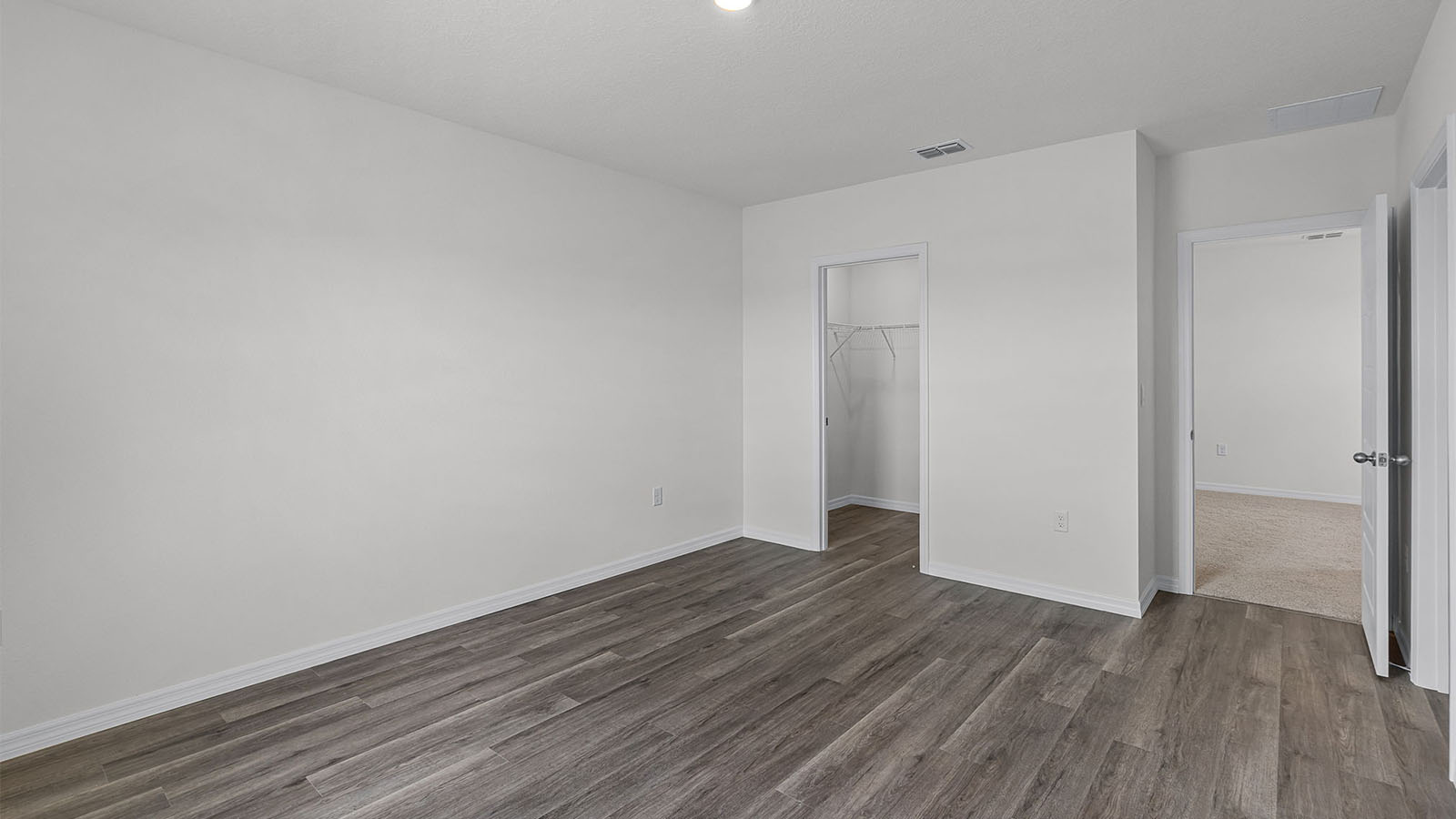 Primary bedroom with luxury vinyl planks