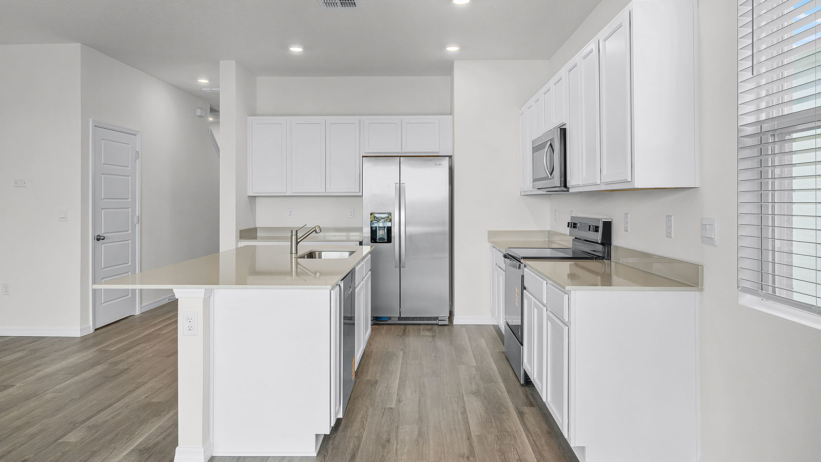 Kitchen Island with Luxury vinyl flooring and stainless steel appliances
