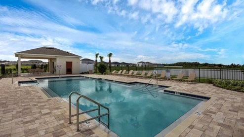 Lake side Pool amenity with covered patio