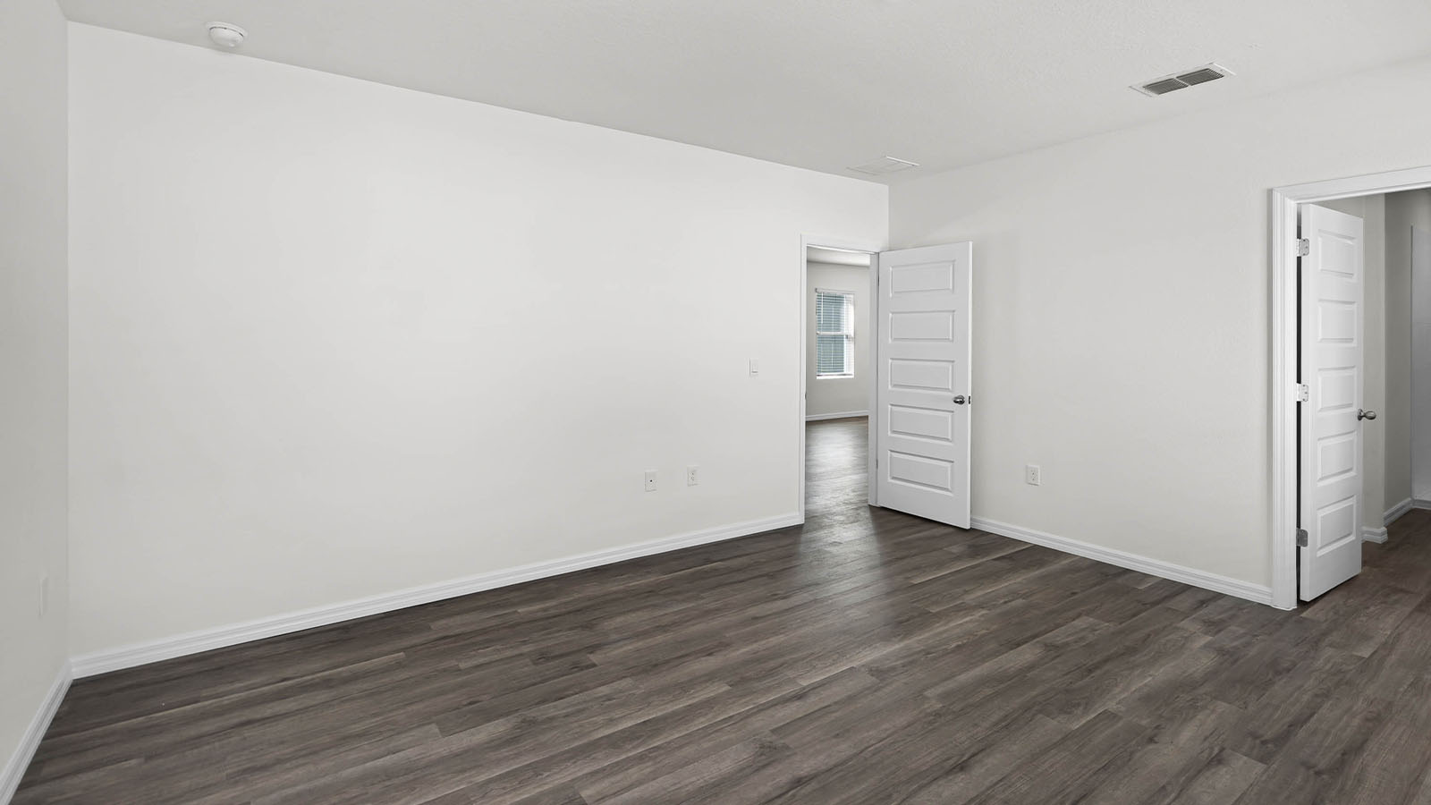 primary bedroom with luxury vinyl plank flooring
